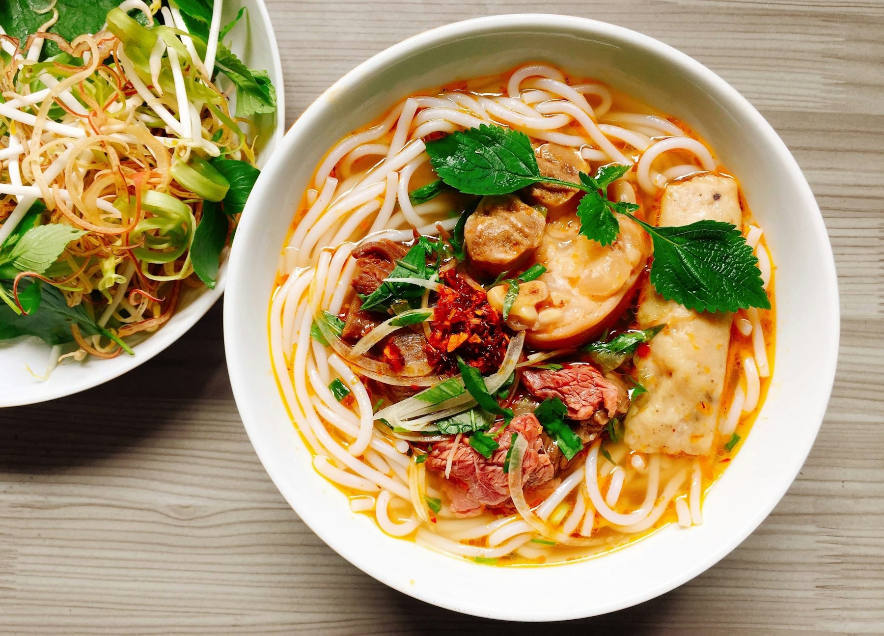 Bún bò Huế with fresh herbs